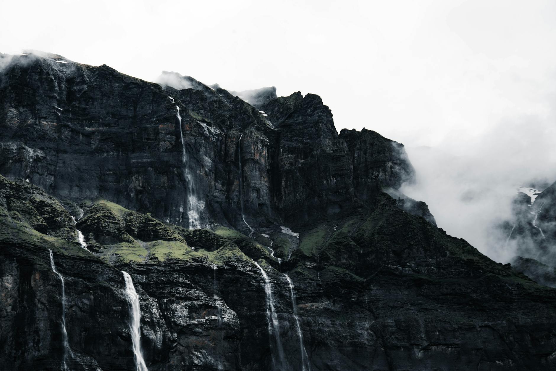 Dramatic waterfalls cascading down the cliffs at Sixt-Fer-à-Cheval, France. A stunning natural landscape.