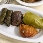 A gourmet platter of dolma, stuffed peppers, and eggplant, perfect for international cuisine lovers.