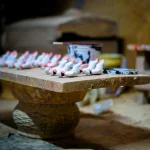 Traditional pottery workshop in Ticul, Yucatán showcasing handcrafted pieces on a table.
