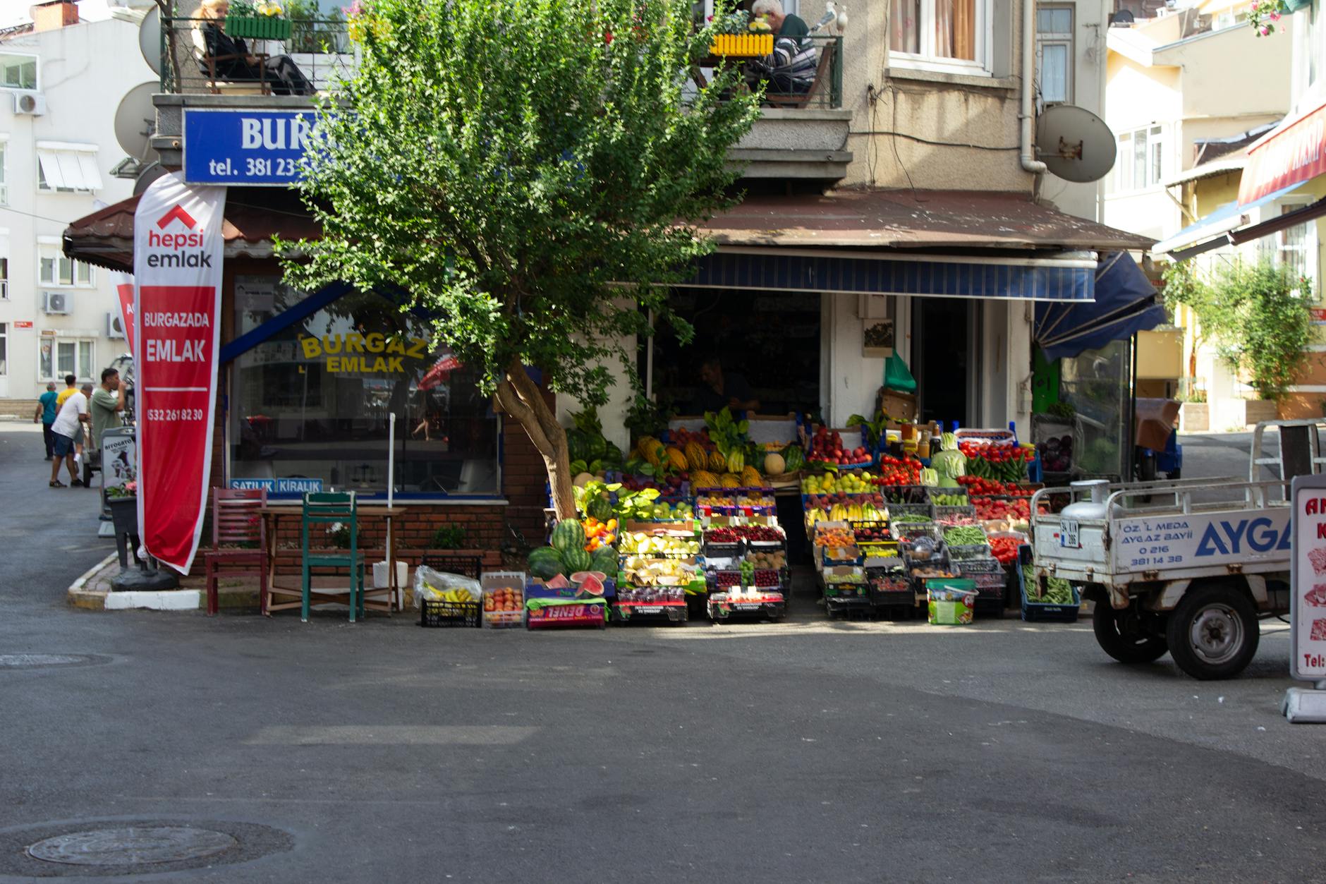 Charming local market stall offering colorful fresh produce in an urban neighborhood. Ideal for food and travel concepts.