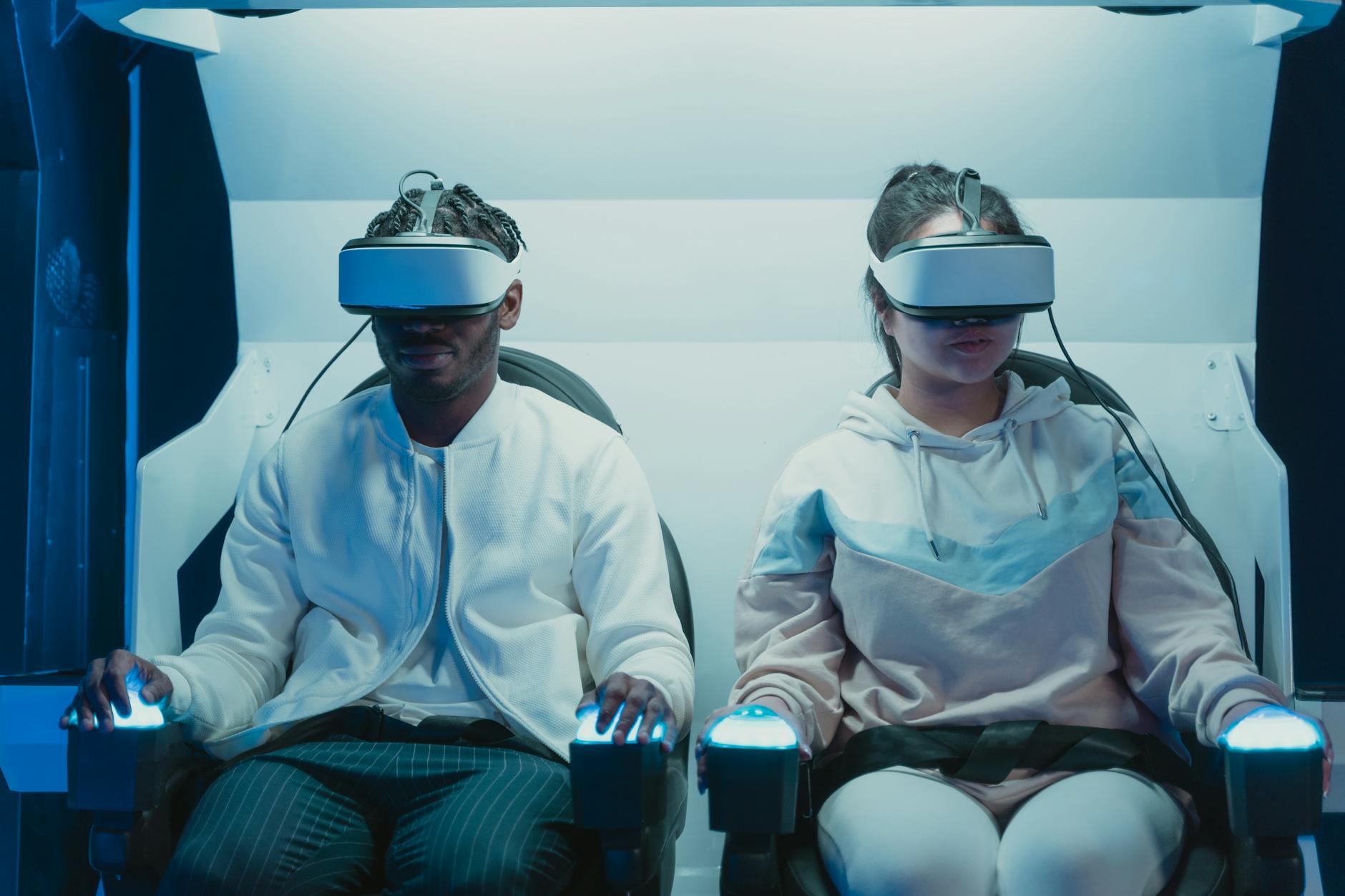 Two young adults immersed in a virtual reality simulation with advanced VR goggles.