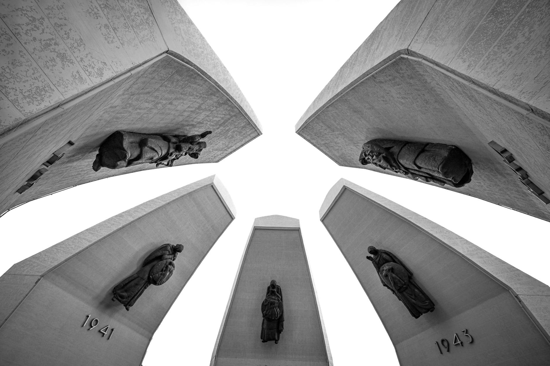 Monochrome view of towering statues depicting significant historical events in Kazakhstan's history.