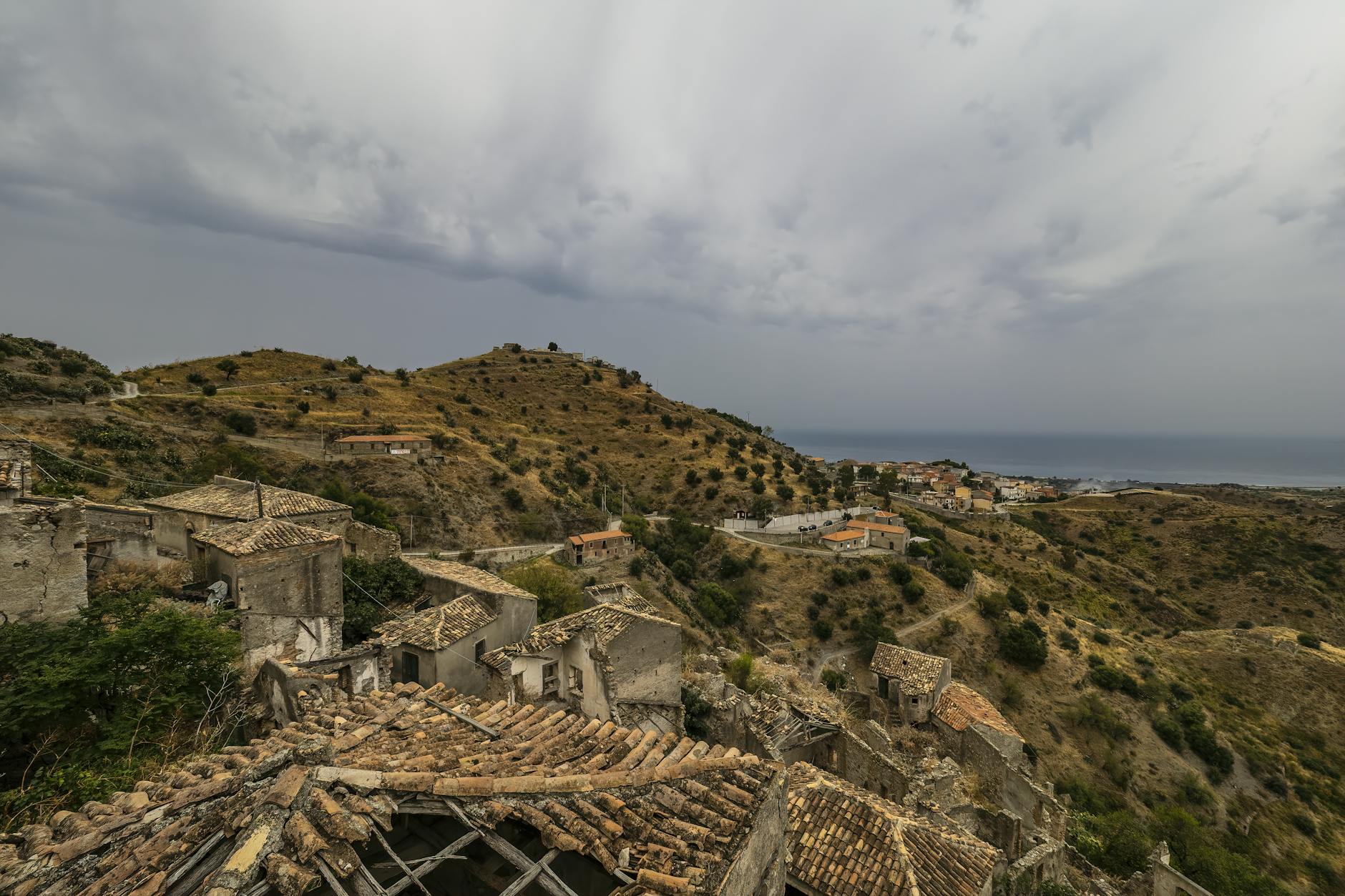 Scenic view of old Italian village ruins with the sea in the background, perfect for travel themes.