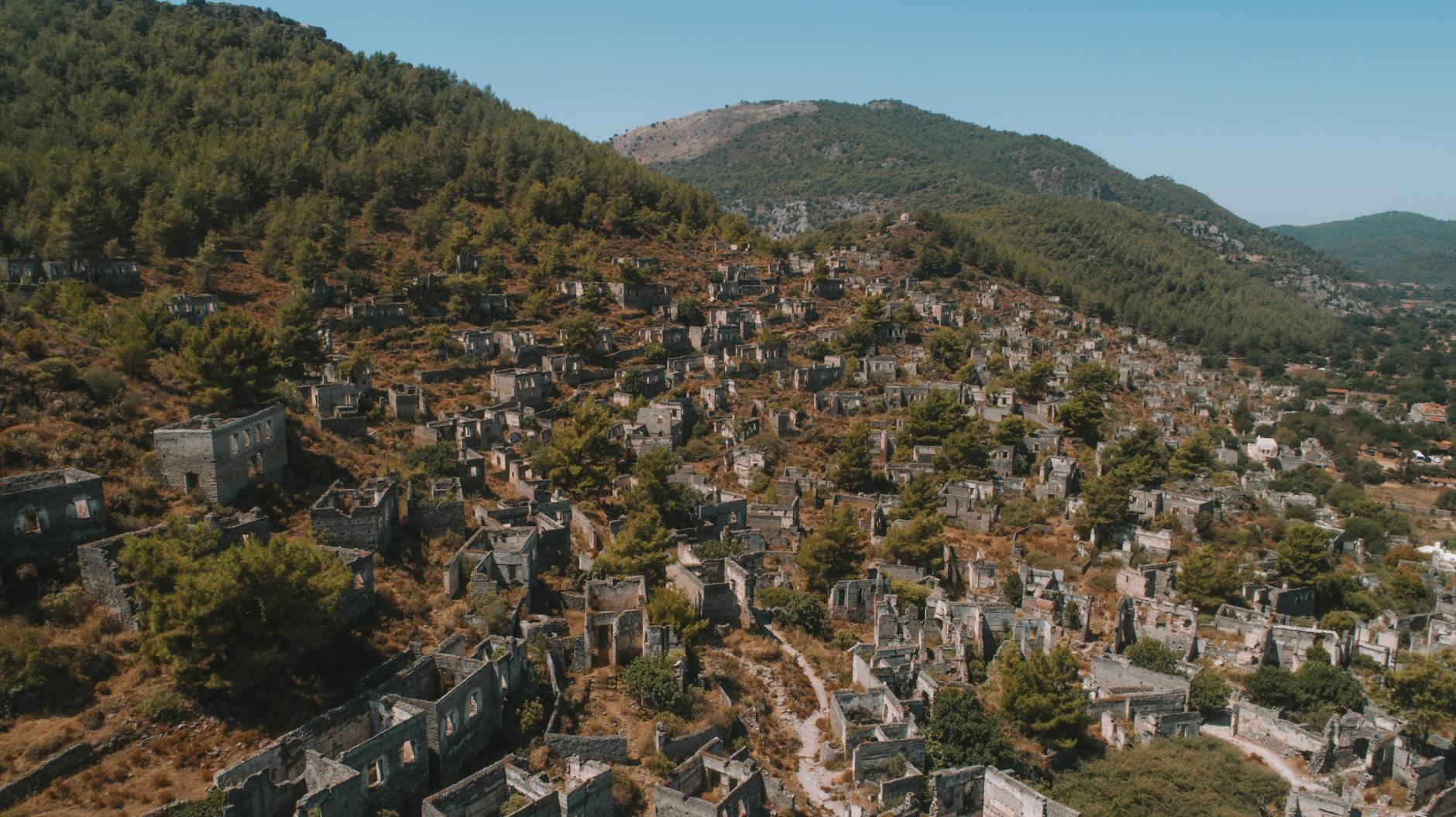 Discover the haunting beauty of Kayaköy ruins nestled among the mountains of Muğla, Türkiye.