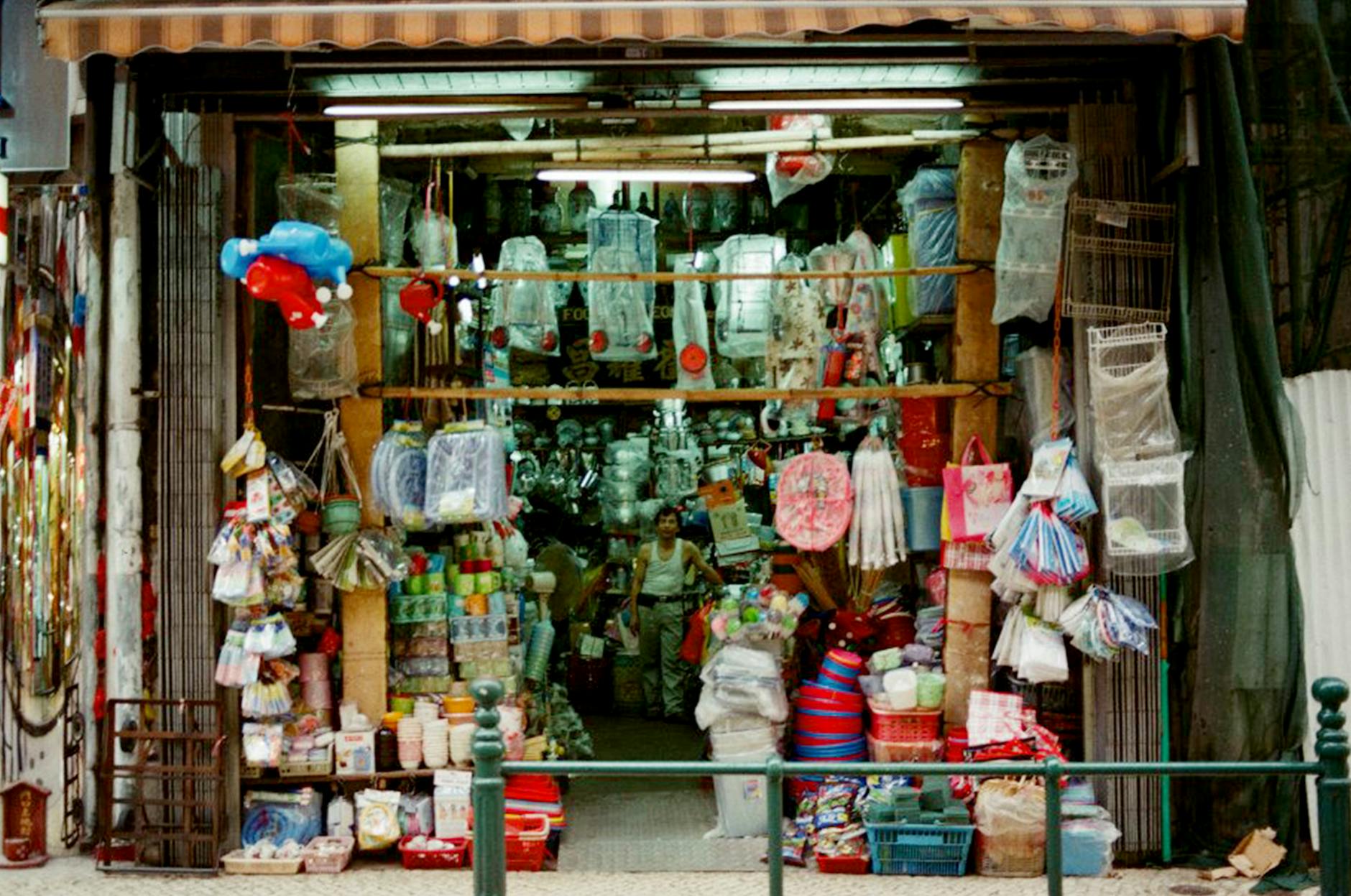 A vibrant market stall in Macau selling various goods and souvenirs.
