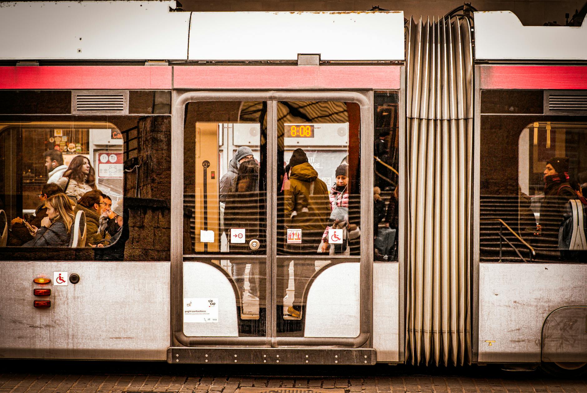 People inside a modern tram in Firenze, Italy, capturing a slice of urban life.