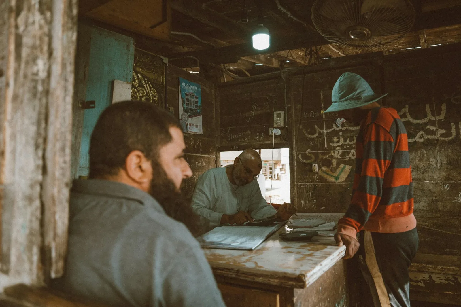 An authentic local market scene in Kafr El-Shaikh with men conducting business indoors.
