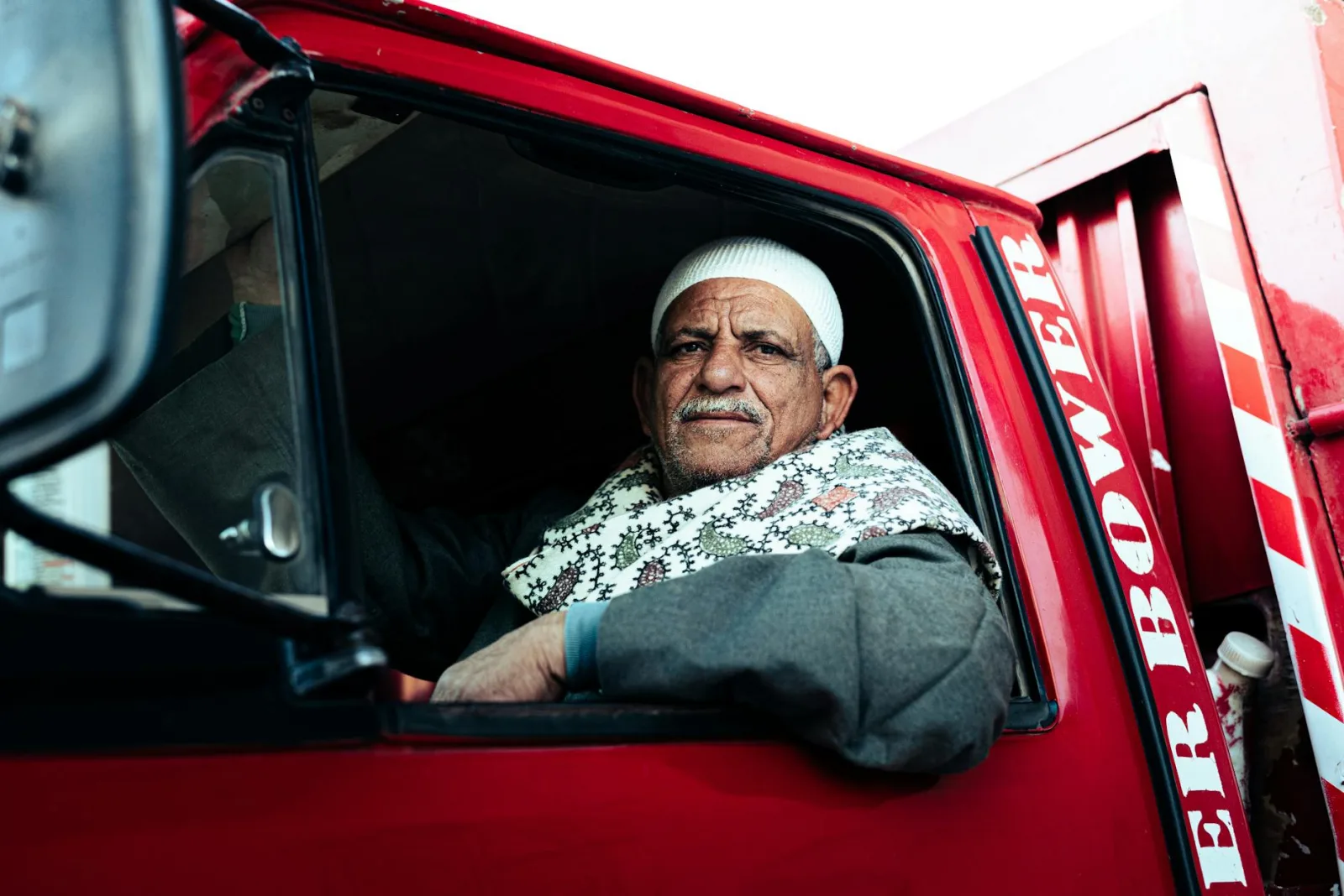 Portrait of an elderly man in a vehicle, depicting everyday life in Egypt.