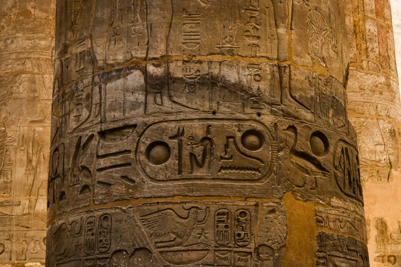Close-up of intricate hieroglyphics on a column in a Luxor Egyptian temple. Historic and cultural richness.