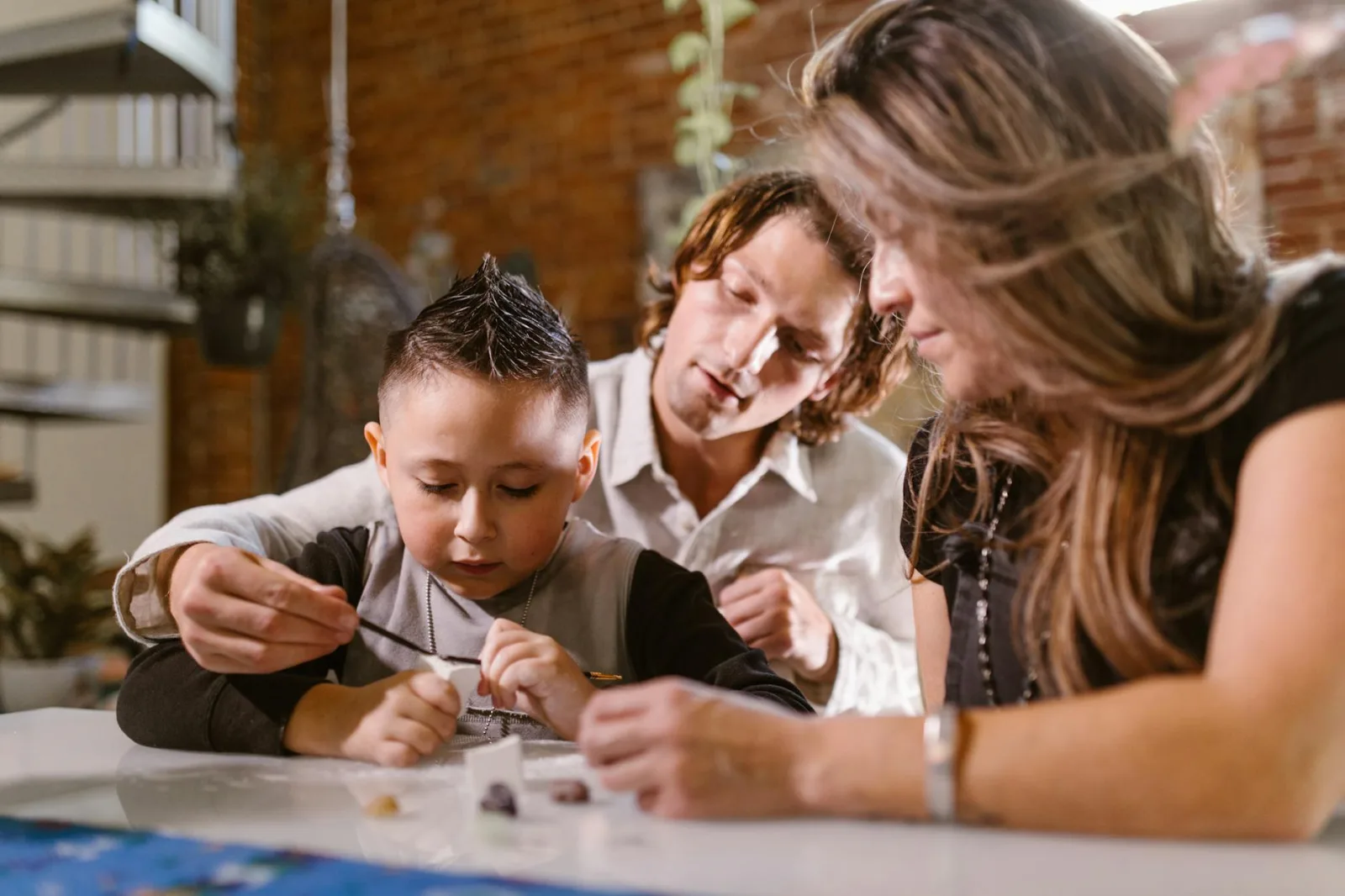 A family enjoys creative bonding activities at home, focusing on craft and play.