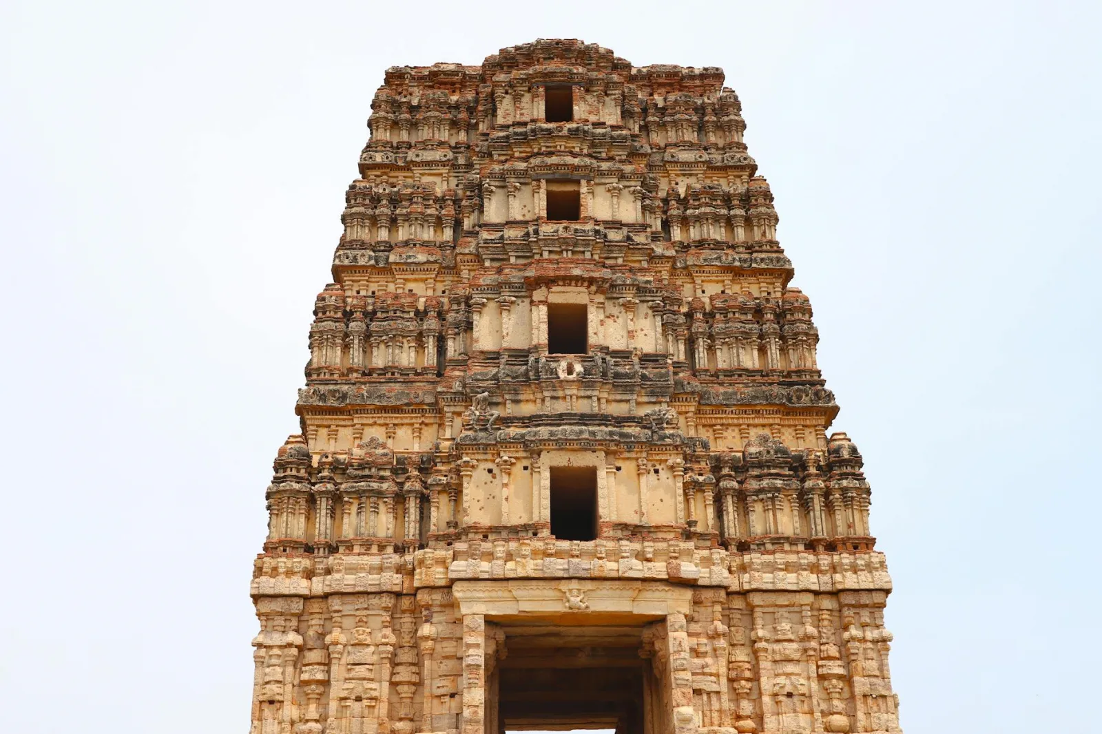 Detailed view of an ancient temple tower showcasing intricate Indian architectural design.