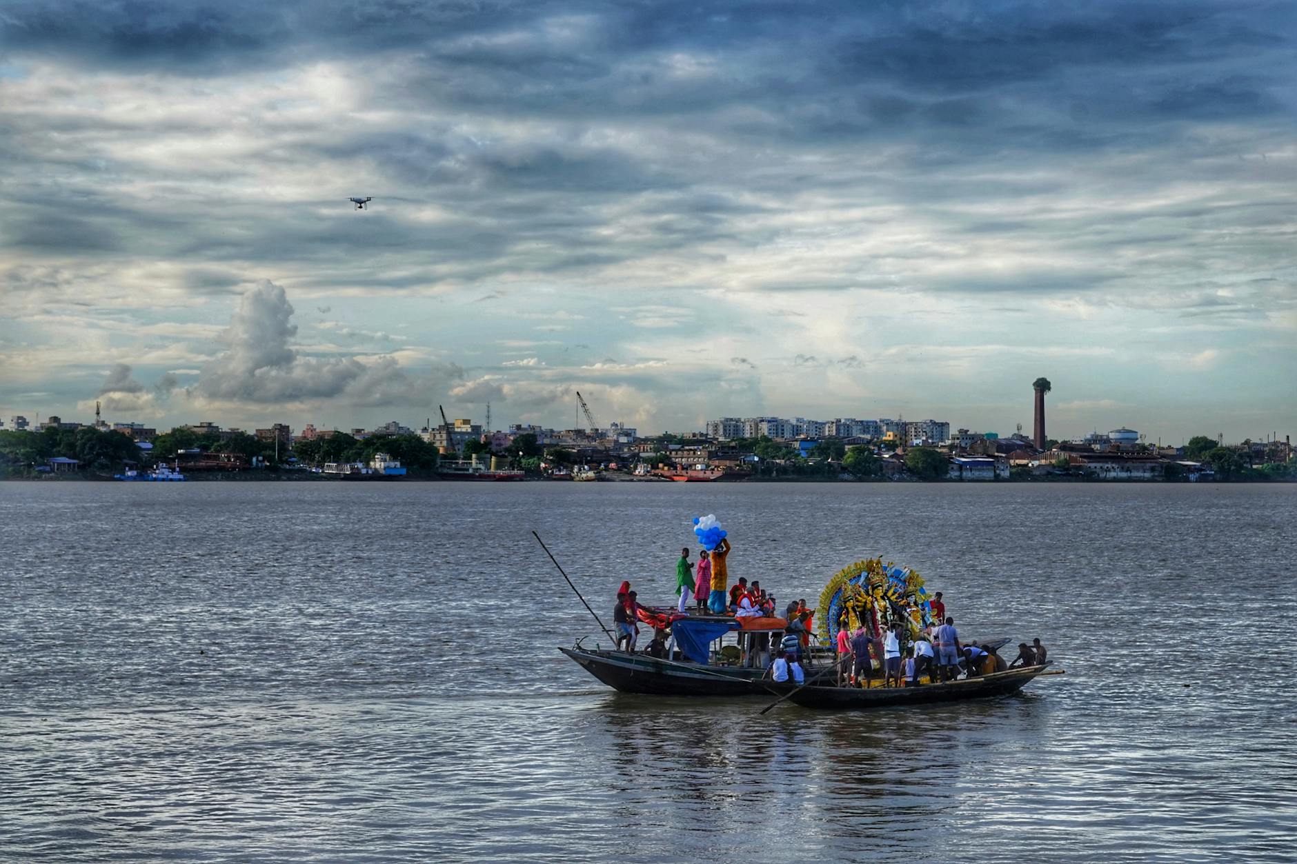 A vibrant cultural celebration on Kolkata's Hooghly River, showcasing traditional festivities.