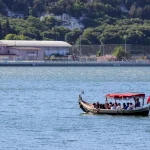 Tourists enjoying a boat ride on the Bosphorus in Istanbul with scenic views of the city.