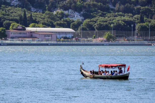 Tourists enjoying a boat ride on the Bosphorus in Istanbul with scenic views of the city.