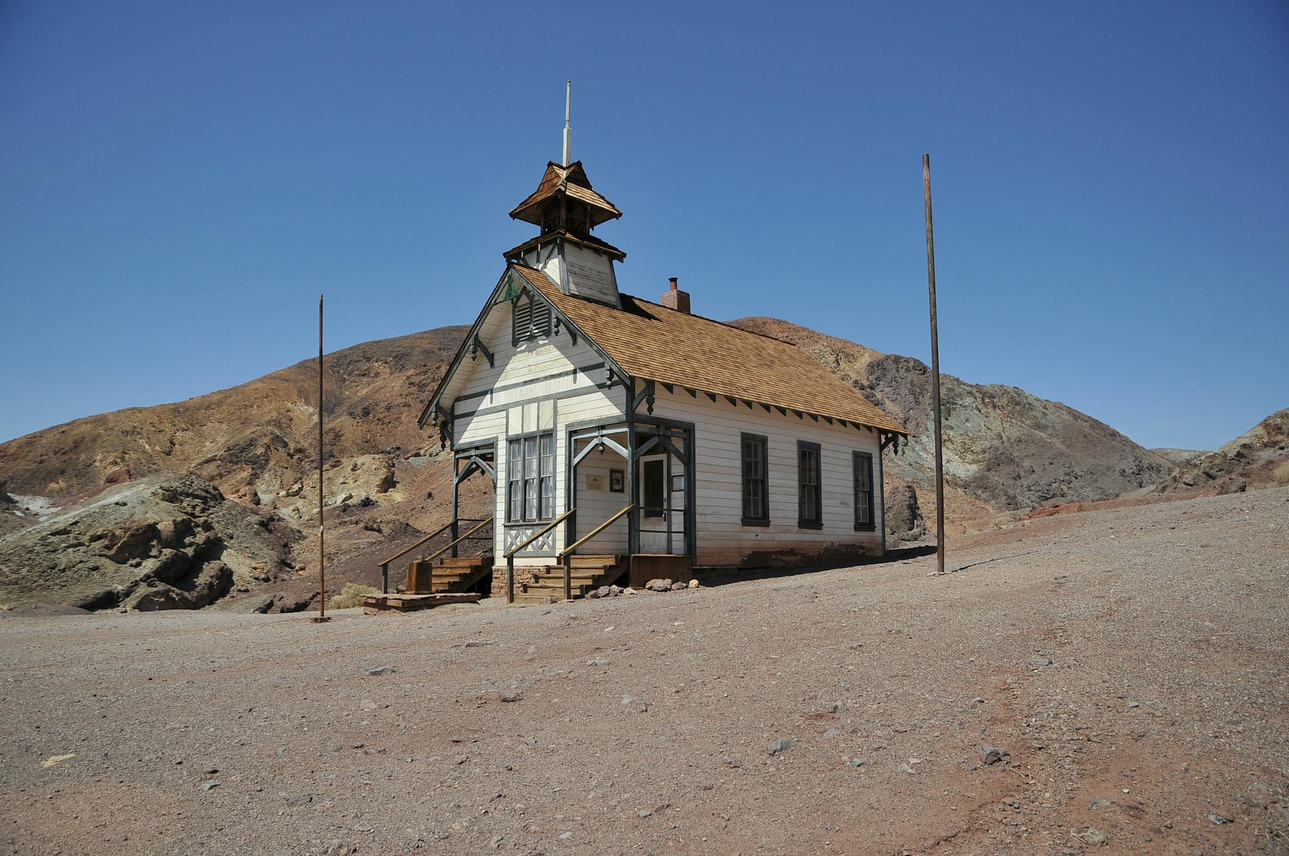 Calico schoolhouse stands isolated in California's historical desert ghost town.