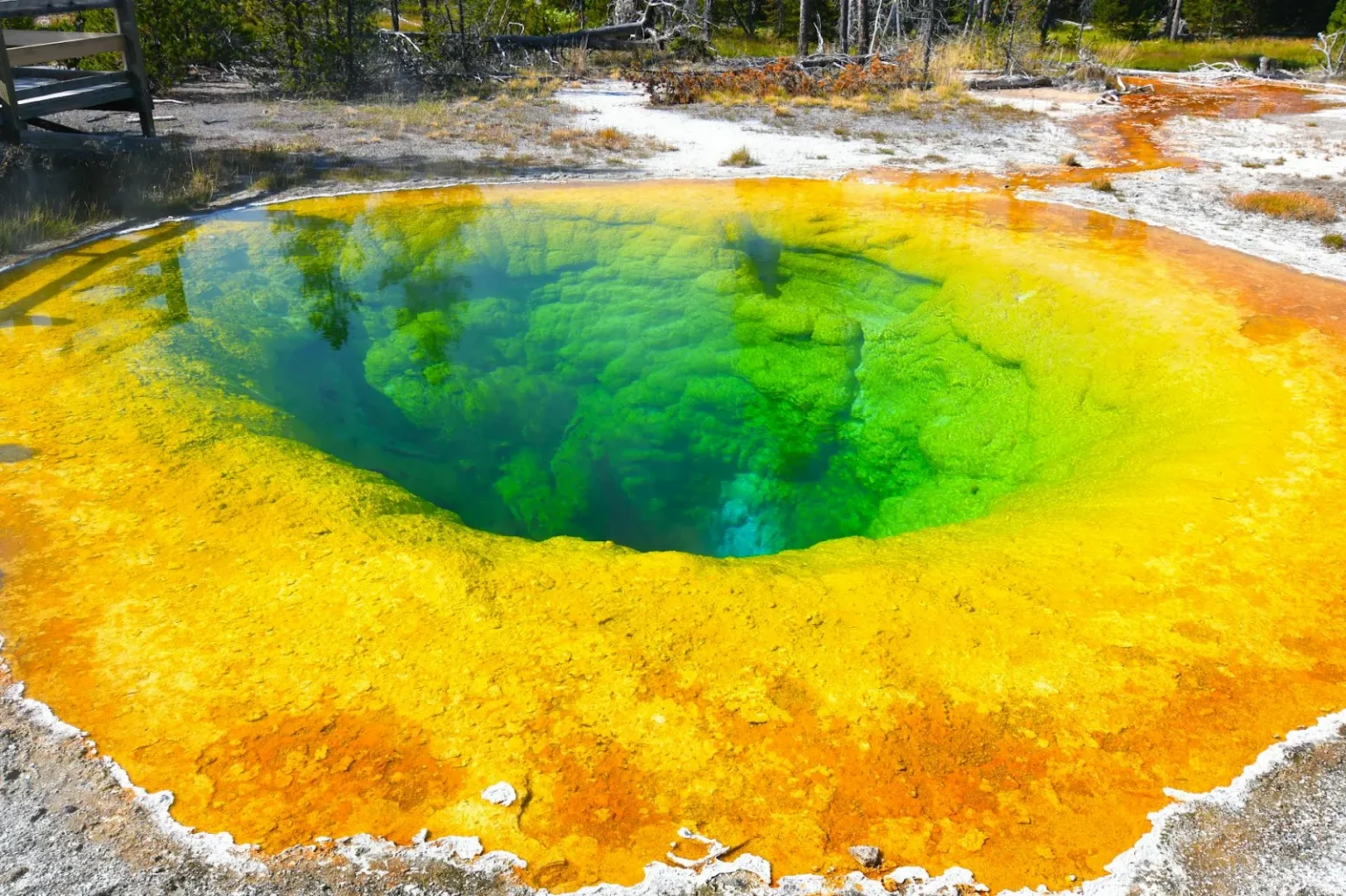 Colorful geothermal hot spring in Yellowstone's Morning Glory Pool with vivid hues.