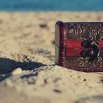 A decorative treasure chest sits on a sunny beach, invoking mystery and adventure.