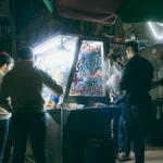 A vibrant street food stall scene in Cairo, Egypt, bustling with activity at night.