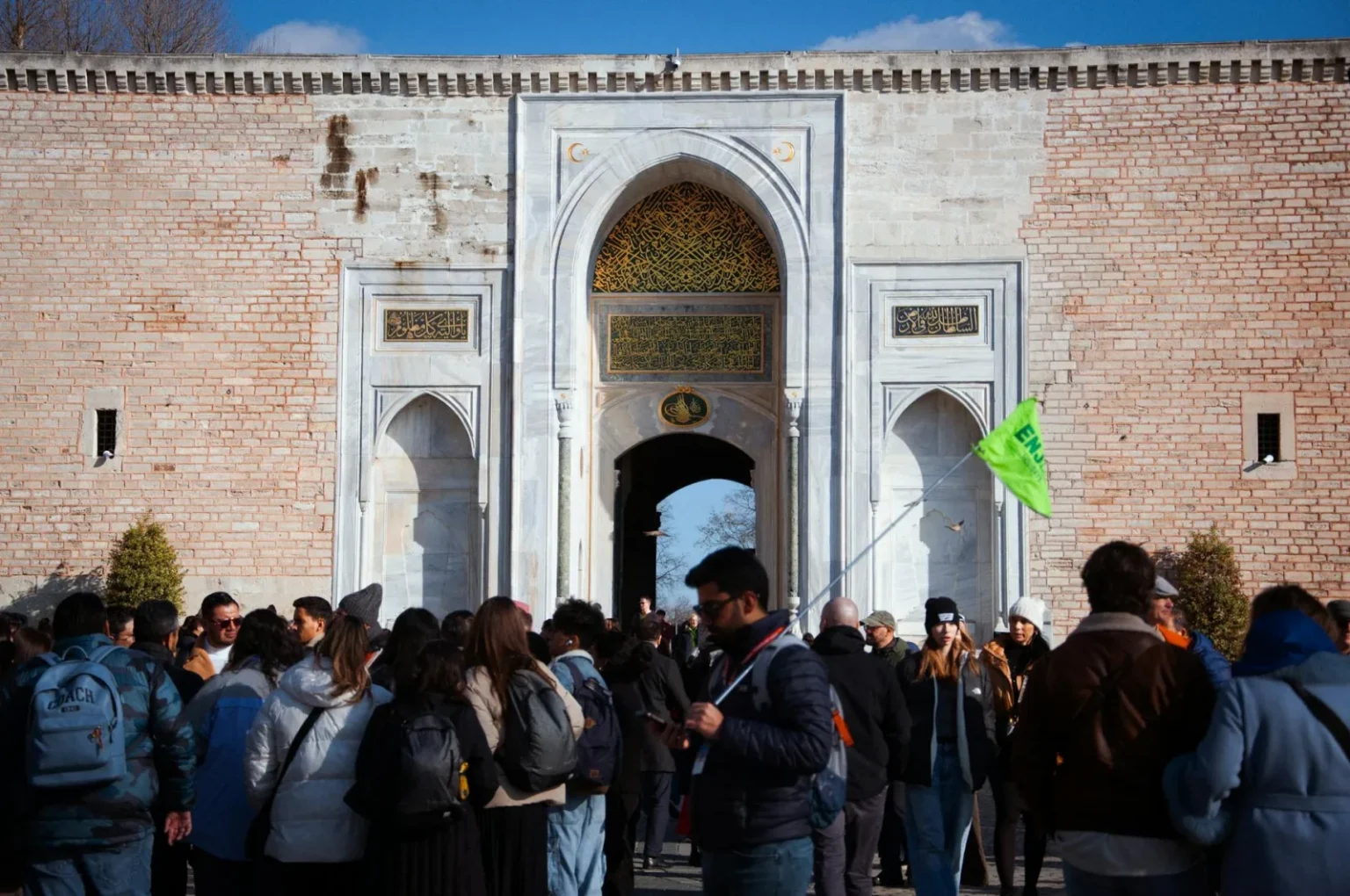Crowd of tourists at the grand entrance of Topkapi Palace in Istanbul, a historical landmark in Turkey.