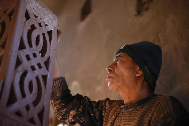 Middle Eastern craftsman sculpting clay with expertise in Cairo, showcasing traditional arts and crafts.