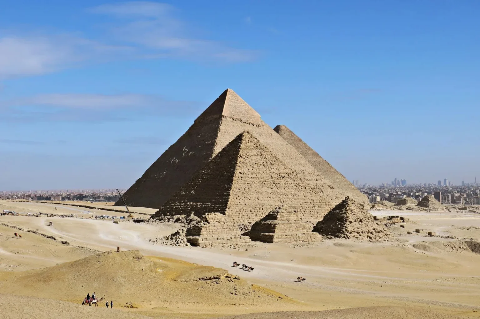 Stunning daytime view of the Great Pyramids of Giza with clear blue skies.