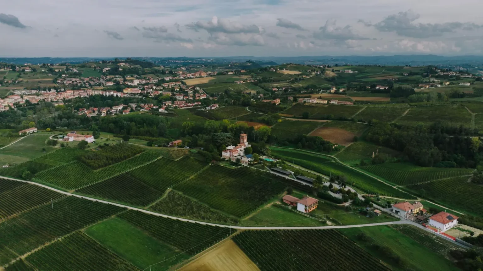 Breathtaking aerial view of the lush vineyards and countryside of Costigliole d'Asti, Piedmont, Italy.