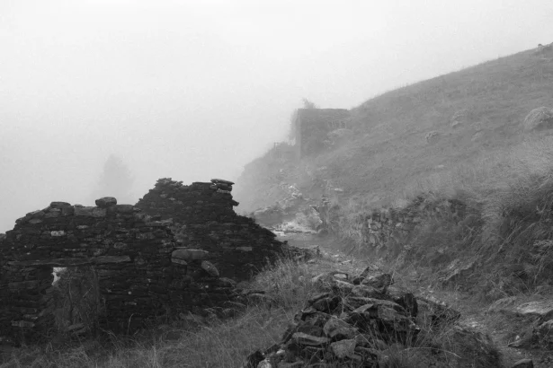 Explore the mysterious fog-covered ruins in Aosta Valley, Italy, offering a hauntingly beautiful view.