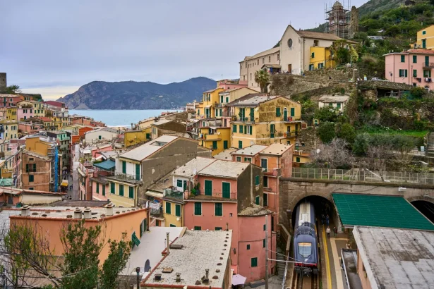 Charming view of colorful Vernazza, a picturesque village in Cinque Terre, Italy with train station.