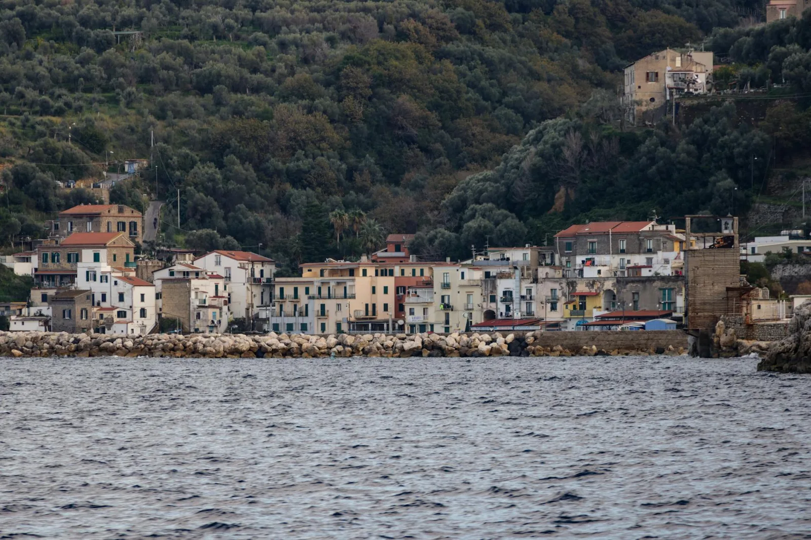 Charming Italian village along the Mediterranean coast with classic architecture and lush greenery.