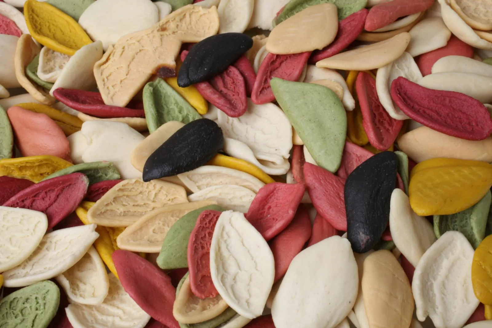Vibrant close-up of multicolored orecchiette pasta, showcasing Italian culinary artistry.