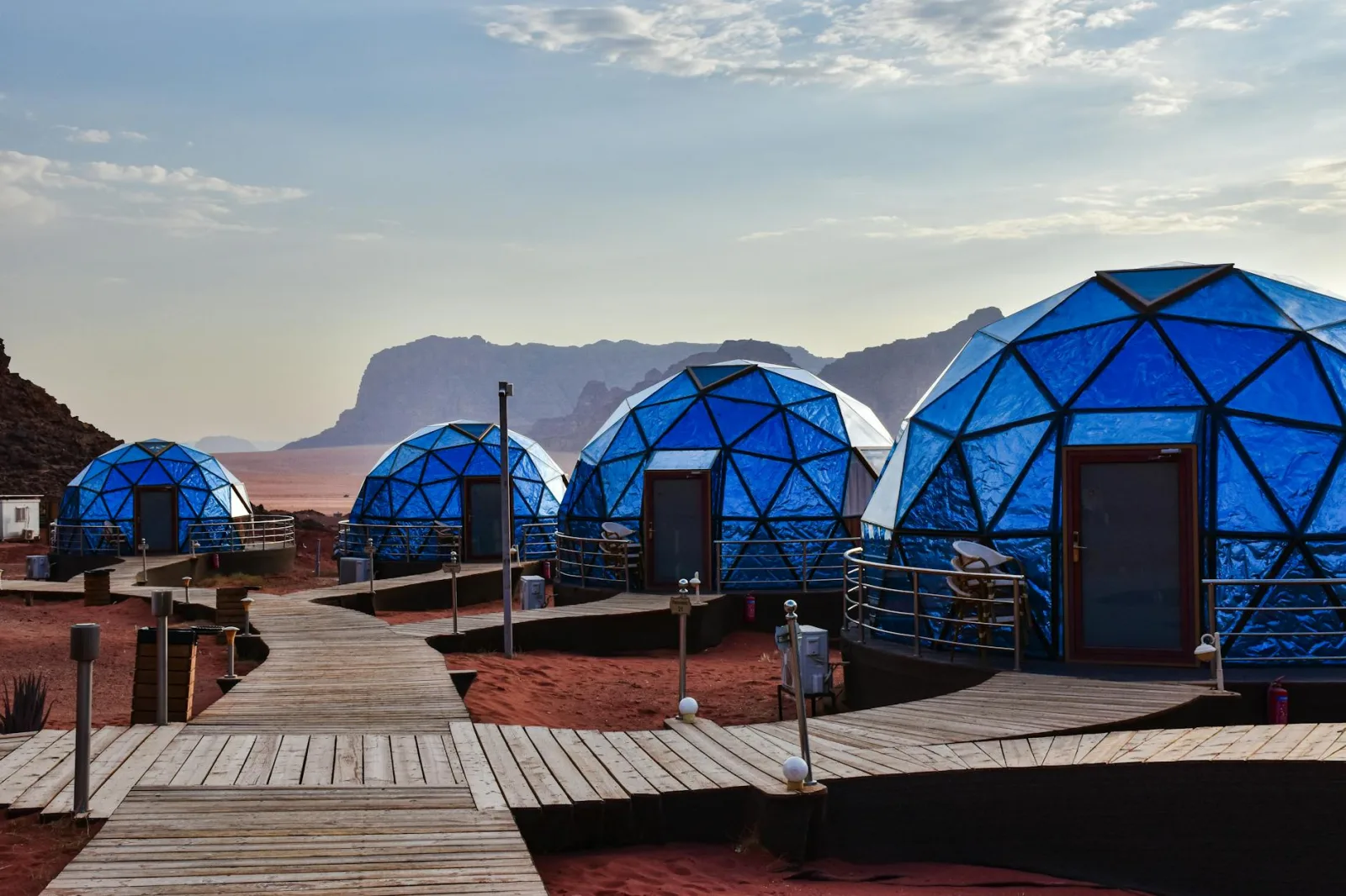 Scenic view of futuristic geodesic domes set in the majestic Wadi Rum desert, blending luxury with nature.
