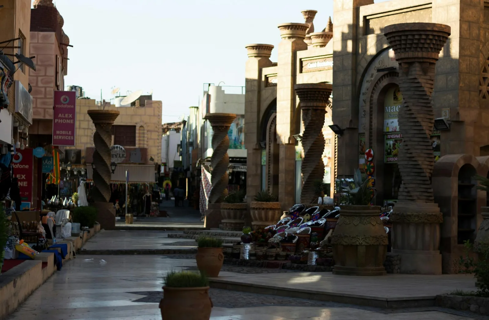 A vibrant street market with unique architectural features basking in the evening light.