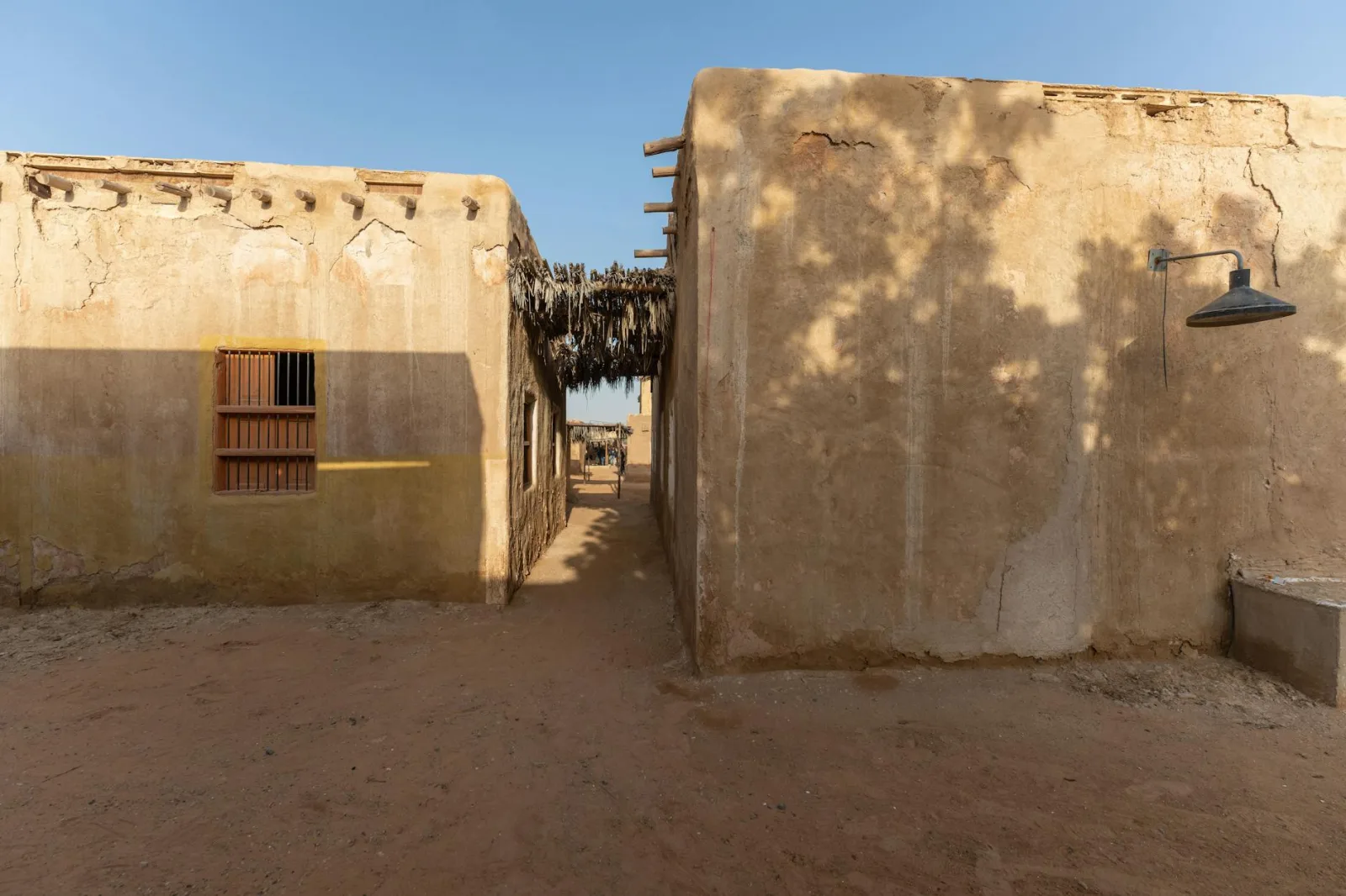 View of traditional mud houses in a desert village during the day.