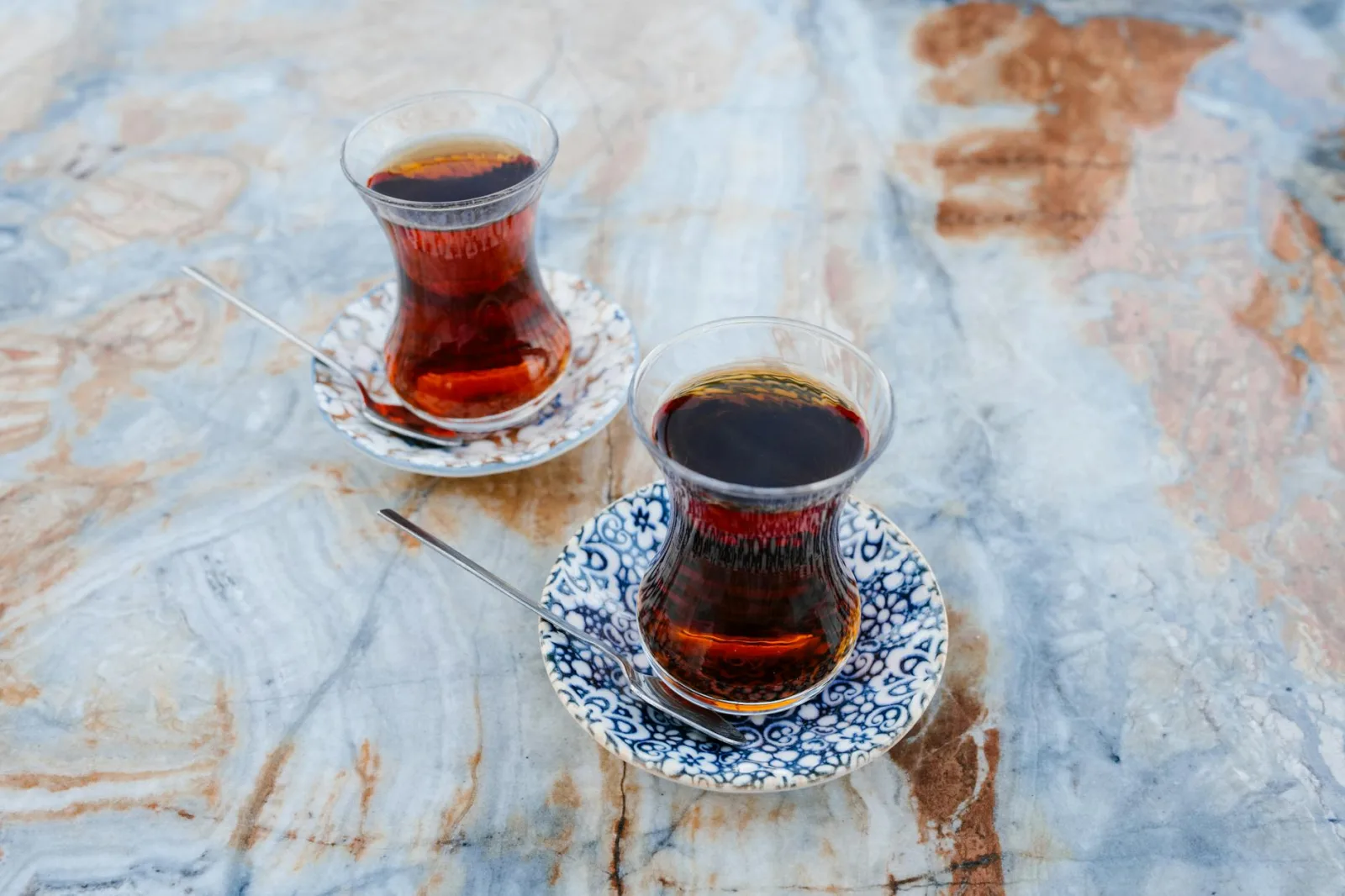 Authentic Turkish tea glasses on decorative marble surface, capturing Istanbul's cultural essence.