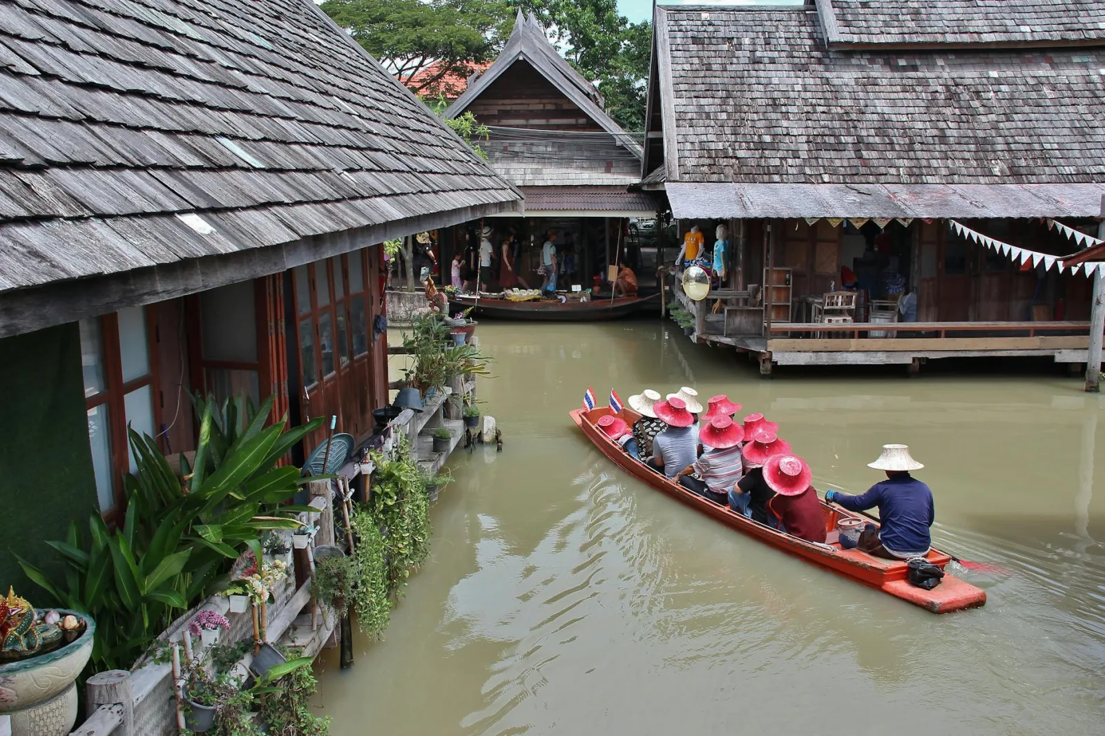 Experience a peaceful canal boat ride through traditional Thai architecture in Muang Pattaya.