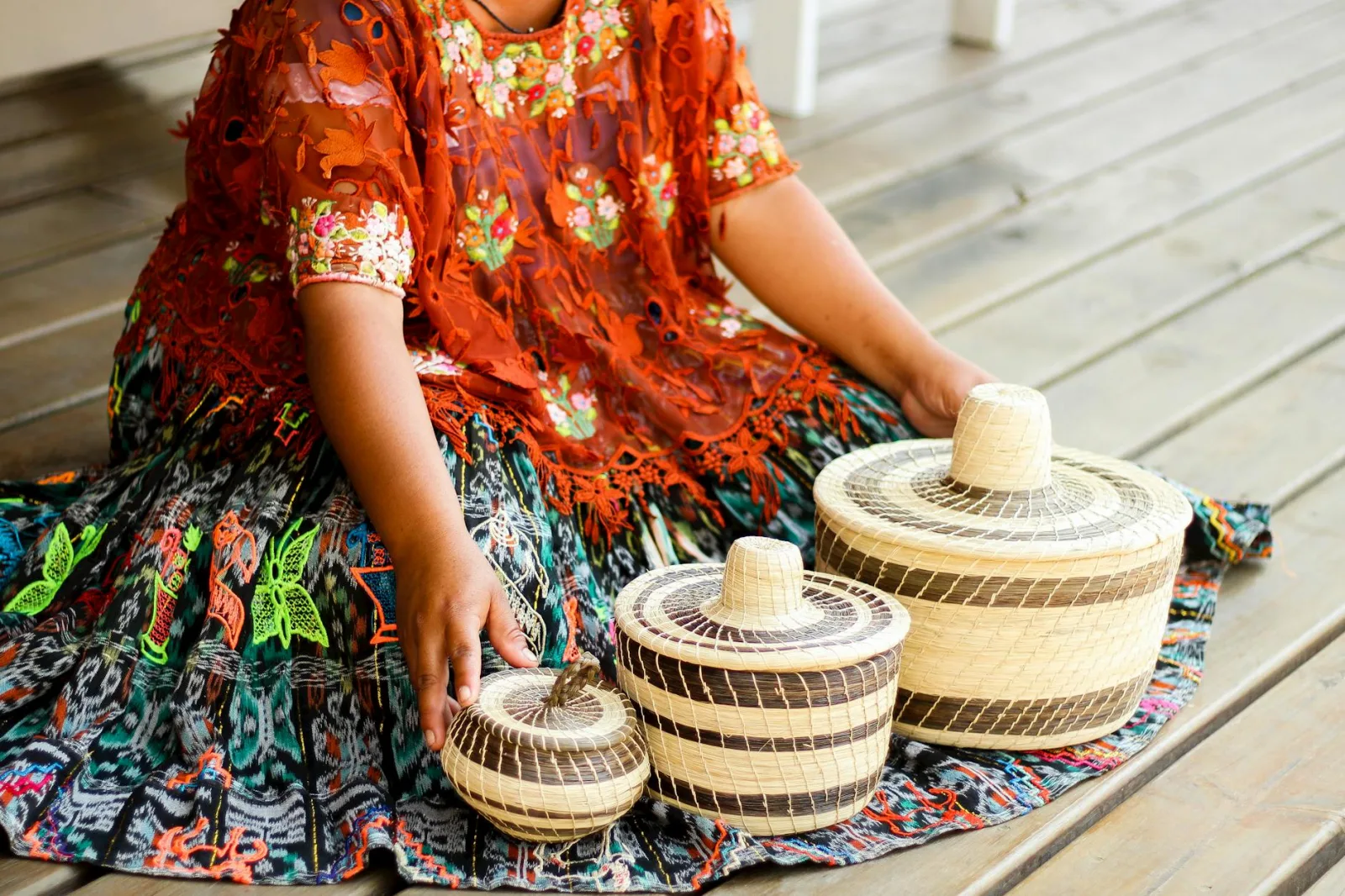 Handcrafted Guatemalan woven baskets paired with colorful traditional attire.