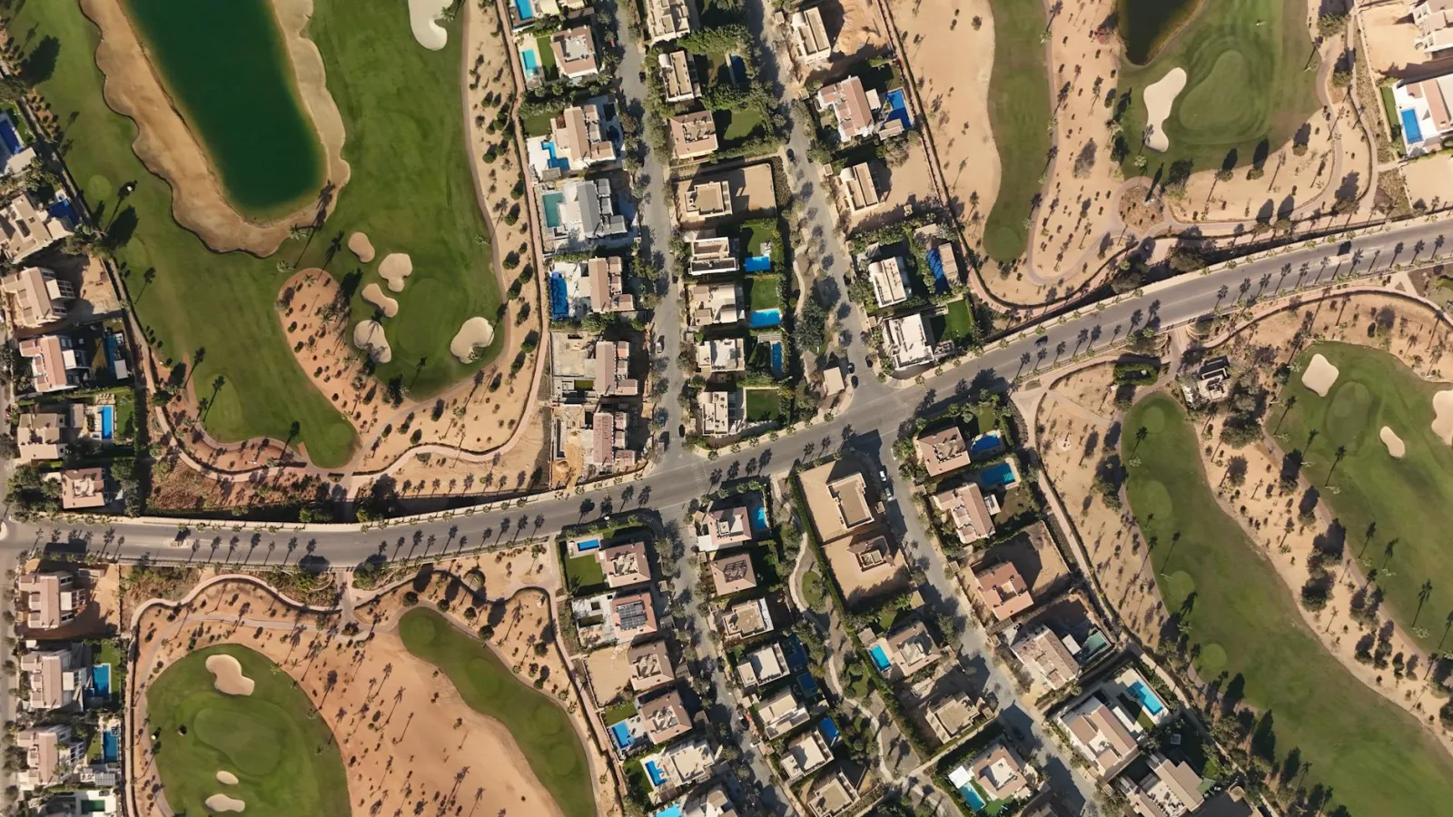 Discover the luxury homes and green golf courses in Sheikh Zayed, Egypt, captured from above.