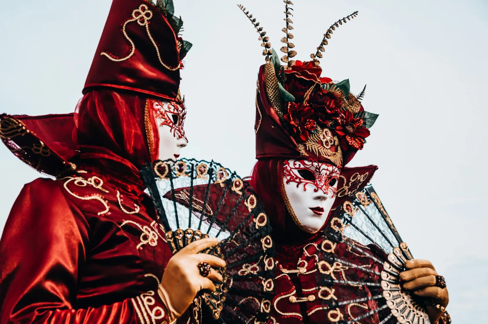 Two individuals in elaborate costumes and masks at the Venice Carnival, showcasing mystery and artistry.