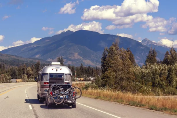 RV traveling on a scenic mountain highway with bikes. Perfect summer adventure.