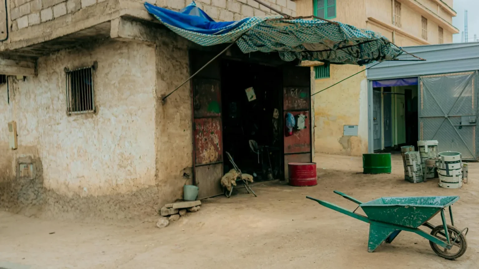 Outdoor workshop with tools and a wheelbarrow in Zaouiat Cheikh, Morocco.