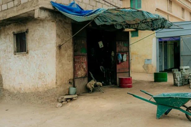 Outdoor workshop with tools and a wheelbarrow in Zaouiat Cheikh, Morocco.