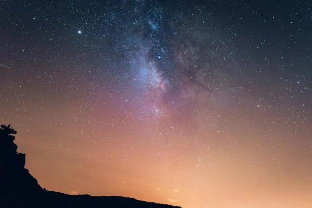 Breathtaking view of the Milky Way over a silhouetted mountain at night in Spain.