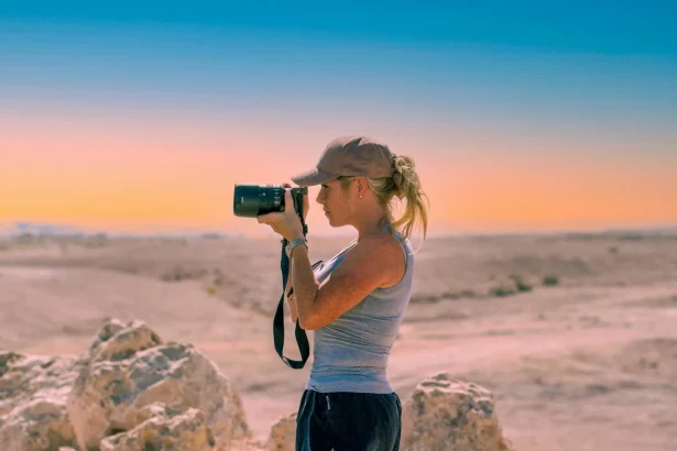 A serene moment of a female photographer capturing the desert's beauty.