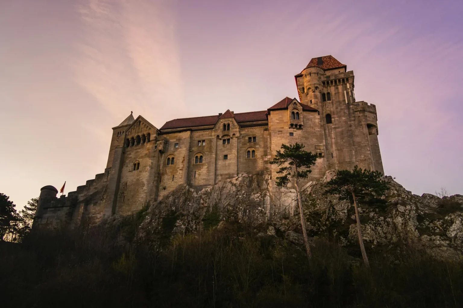 Majestic view of Liechtenstein Castle in Austria during a picturesque sunset.