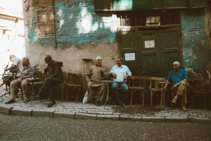 Local men enjoy a casual gathering outside a café in Cairo's historic Al-Darb Al-Ahmar district.