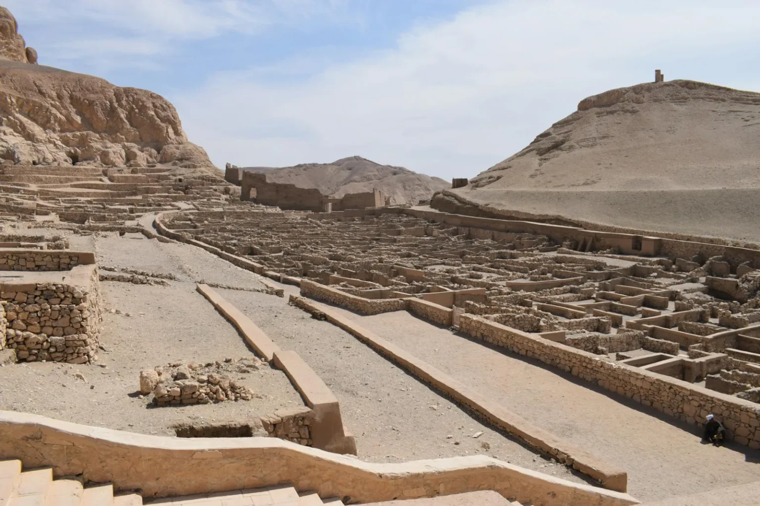 Explore the historic ruins of Deir el-Medina, an ancient village in Egypt's desert landscape.
