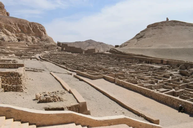 Explore the historic ruins of Deir el-Medina, an ancient village in Egypt's desert landscape.