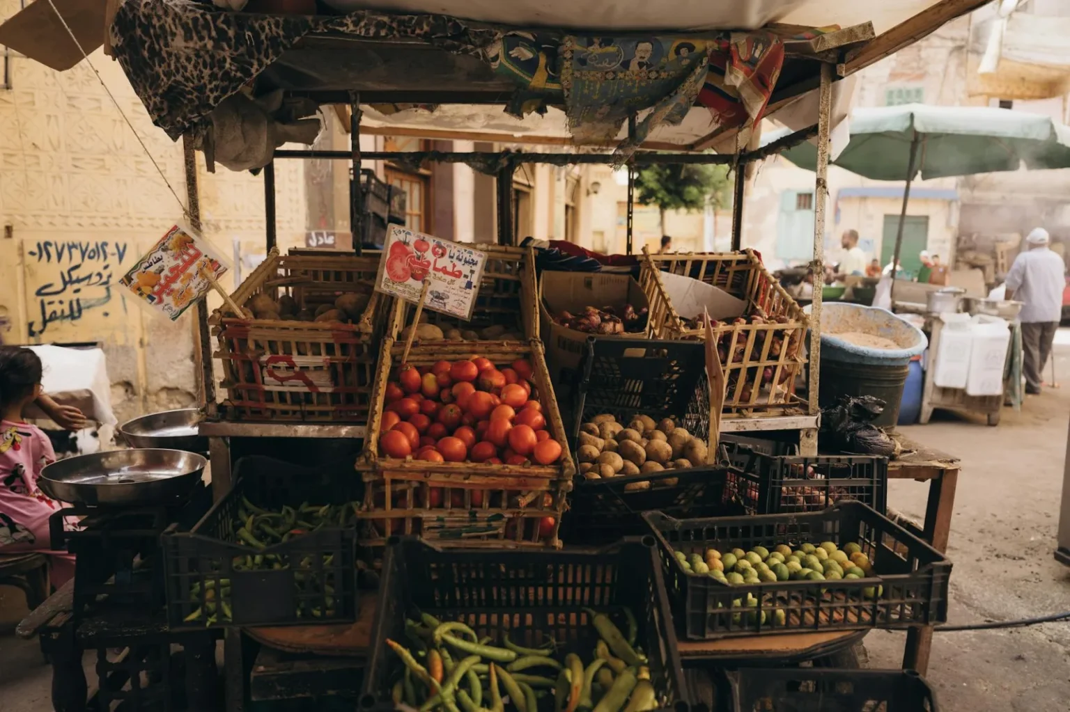 A vibrant street market in Alexandria, Egypt displaying fresh produce and local culture.