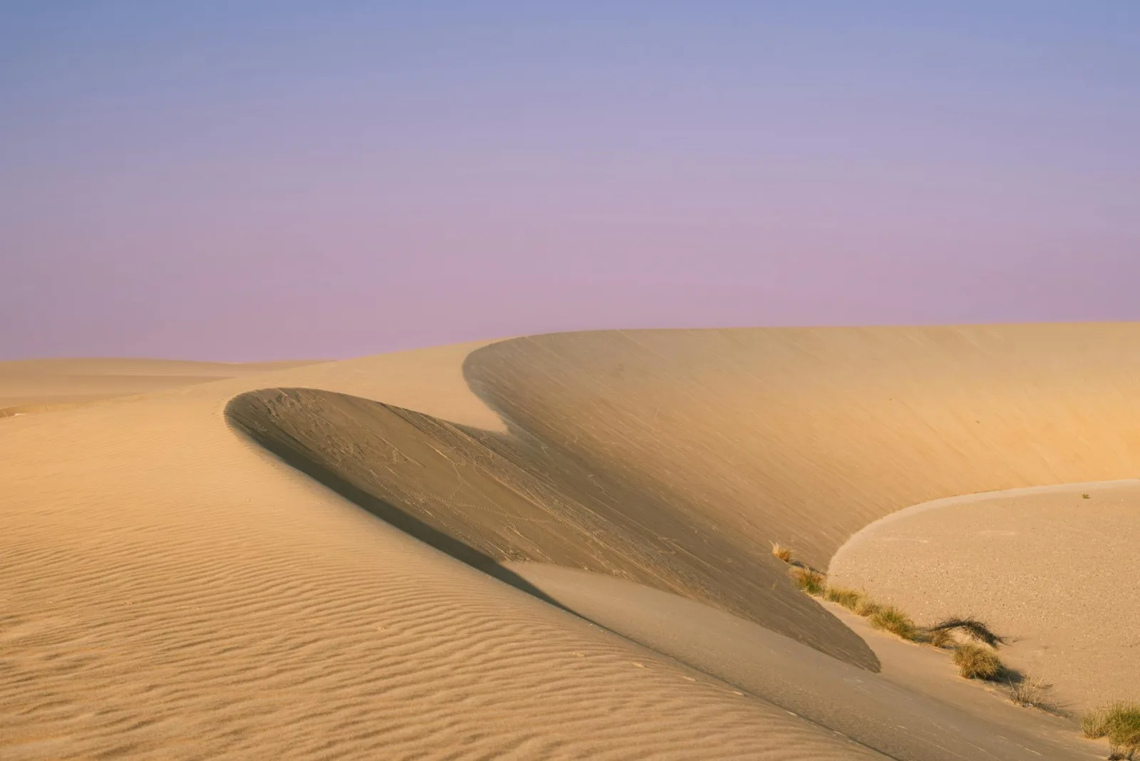 Stunning view of serene sand dunes under a pastel sky in Saudi Arabia's desert