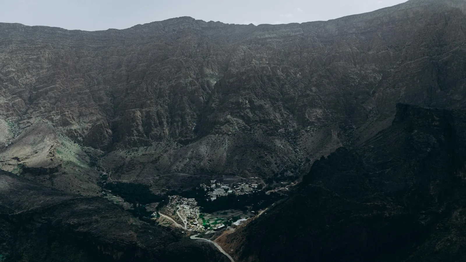 A stunning aerial shot of Oman's rugged mountains and a hidden village.